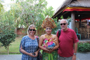 Two tourists and a Balinese barong dancer