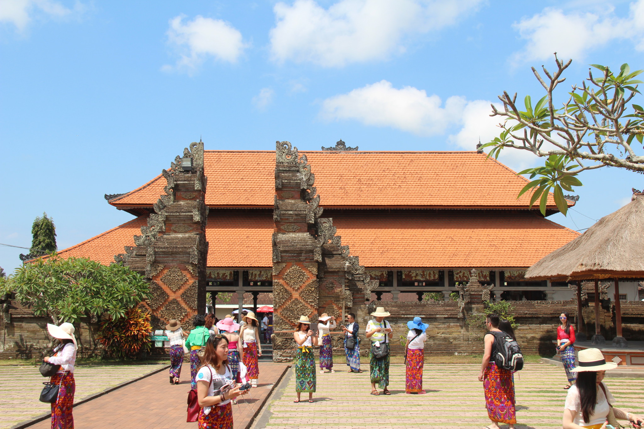Drive in Central Bali: temple visitors dressed in sarongs Drive in Central Bali: temple visitors dressed in sarongs
