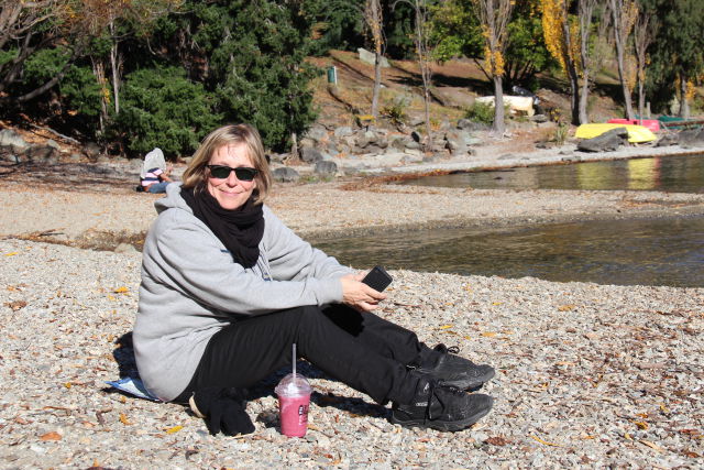 Sitting on Lake Wakatipu beach