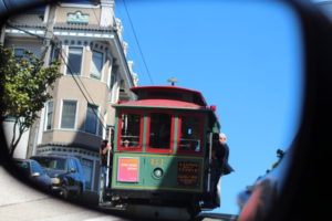 San Francisco cable car from car mirror