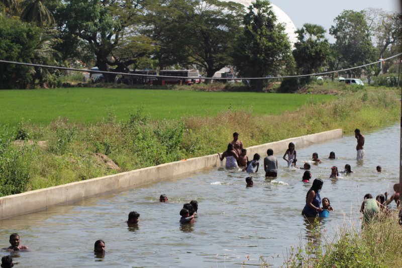 Tissamaharama locals bathing in a canal
