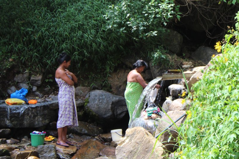 Washing laundry in waterfall, Sri Lanka tea country