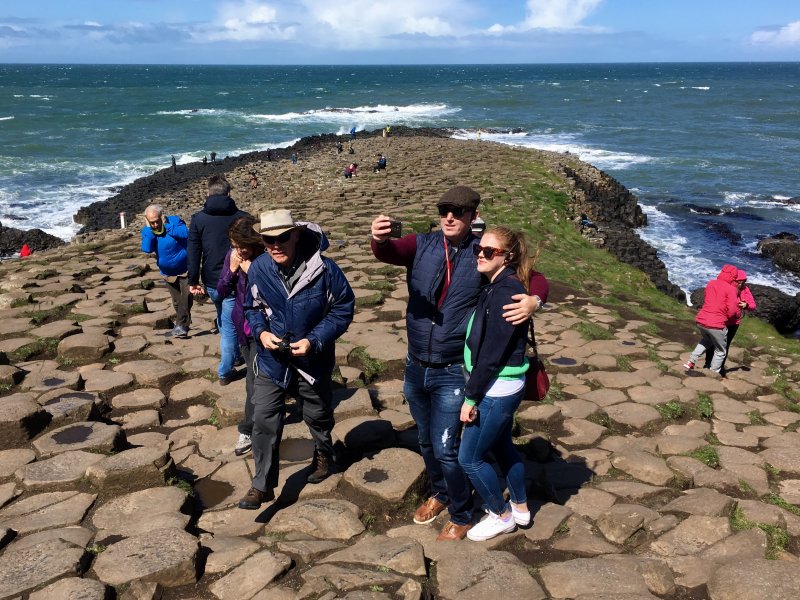 Tourists on Giants Causeway stone columns