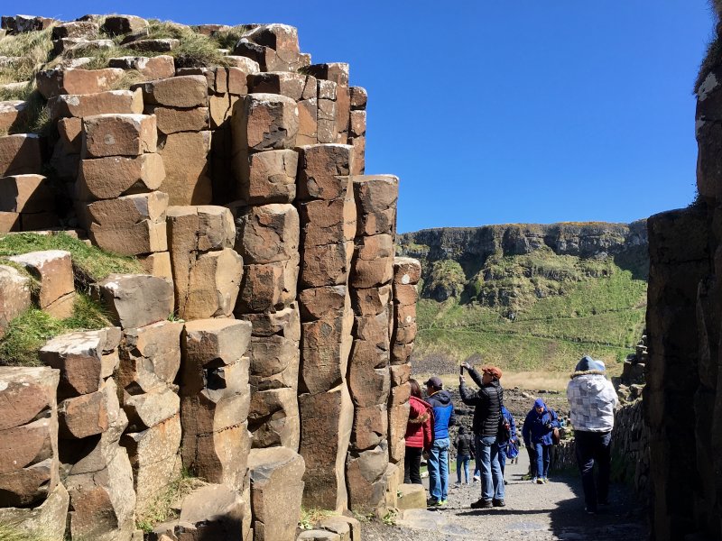 Tourists photographing Giants Causeway columns