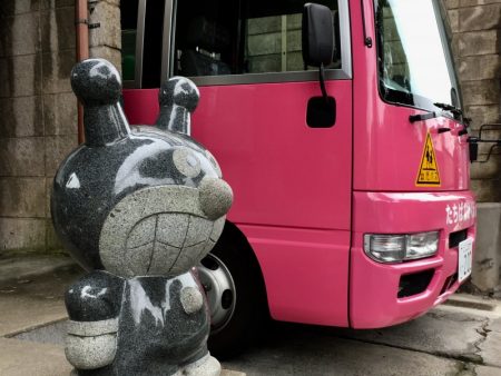 anaka school gate stone statue and school bus