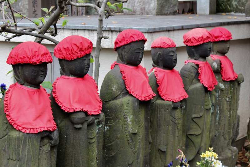 Japanese Ojizosama statues with hats and bibs