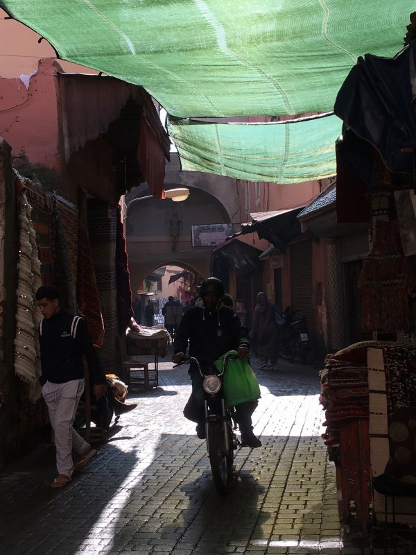 Motorbike speeding in the souks of Marrakech, Morocco