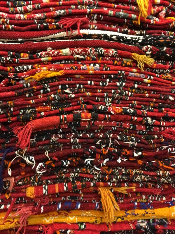 Piled Moroccan carpets in the souks of Marrakech