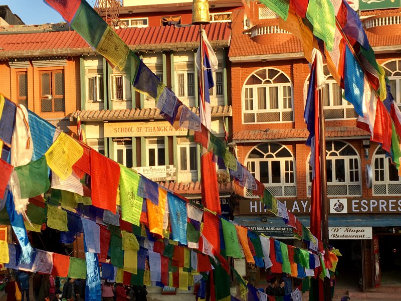 Square around Boudanath stupa Boudanath Stupa prayer flags and surrounding townhouses