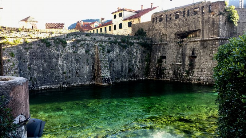 Kotor city wall and green water Kotor city wall and green water