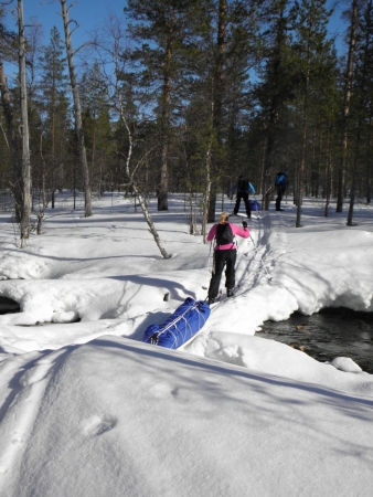 Ski tour in Lapland, crossing a river in Lankojärvi