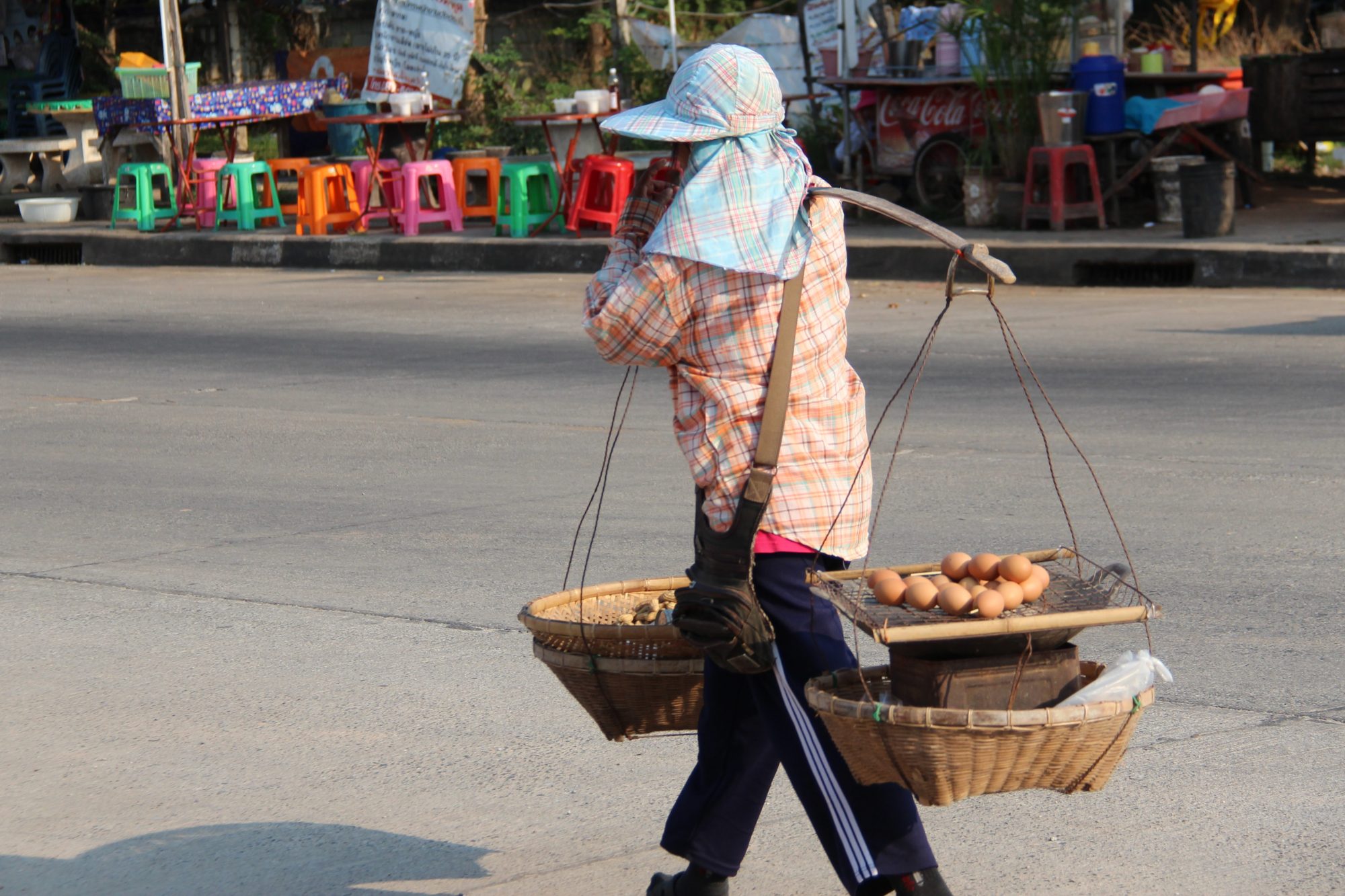 Thai village life: carrying eggs in baskets