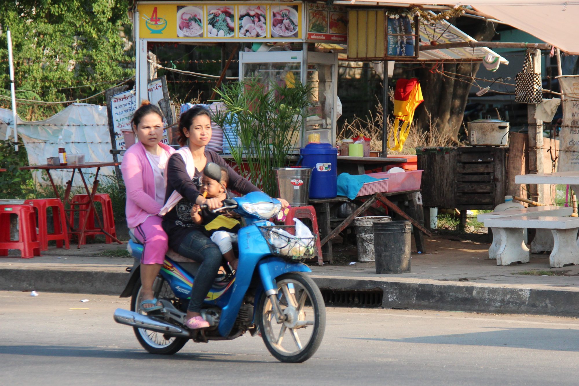 Thai village life: riding a motor bike