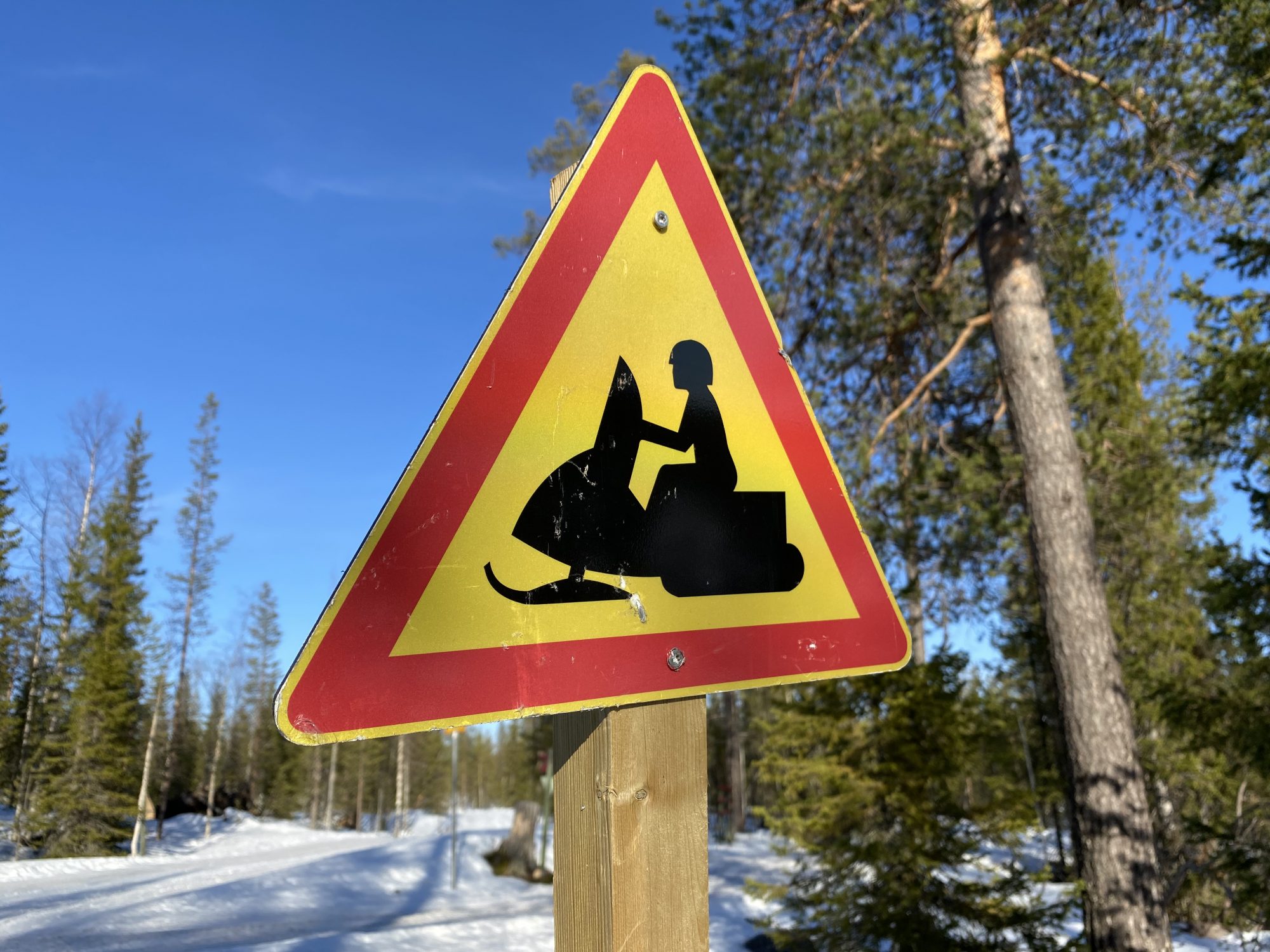 A snowmobile trail Arctic Lapland spring: snowmobiling in the wild
