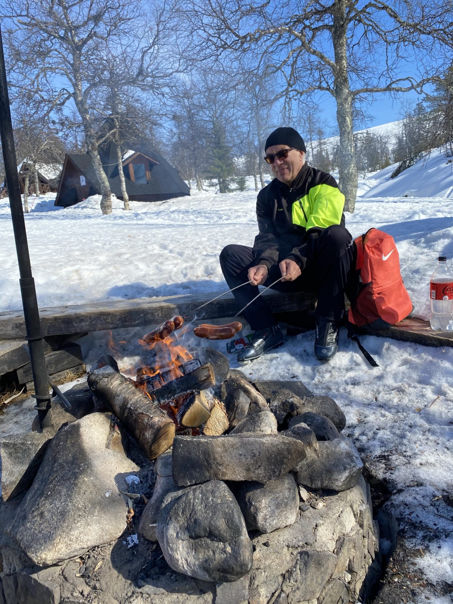 Around a camp fire: traditional sausage lunch Preparing lunch in Lapland wilderness